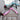 Dog car seat-belt tethers in sky blue, black and pink laid on a car seat