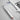 Silver dog dental scaler charging via USB cable from a laptop