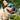 French bulldog wearing black dog goggles with mirrored lens outdoors