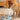 Shiba inu dog using the interactive puzzle slow feeder bowl on the floor